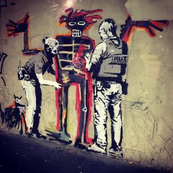 Banksy - Basquiat being welcomed by the Metropolitan Police_pa_stre